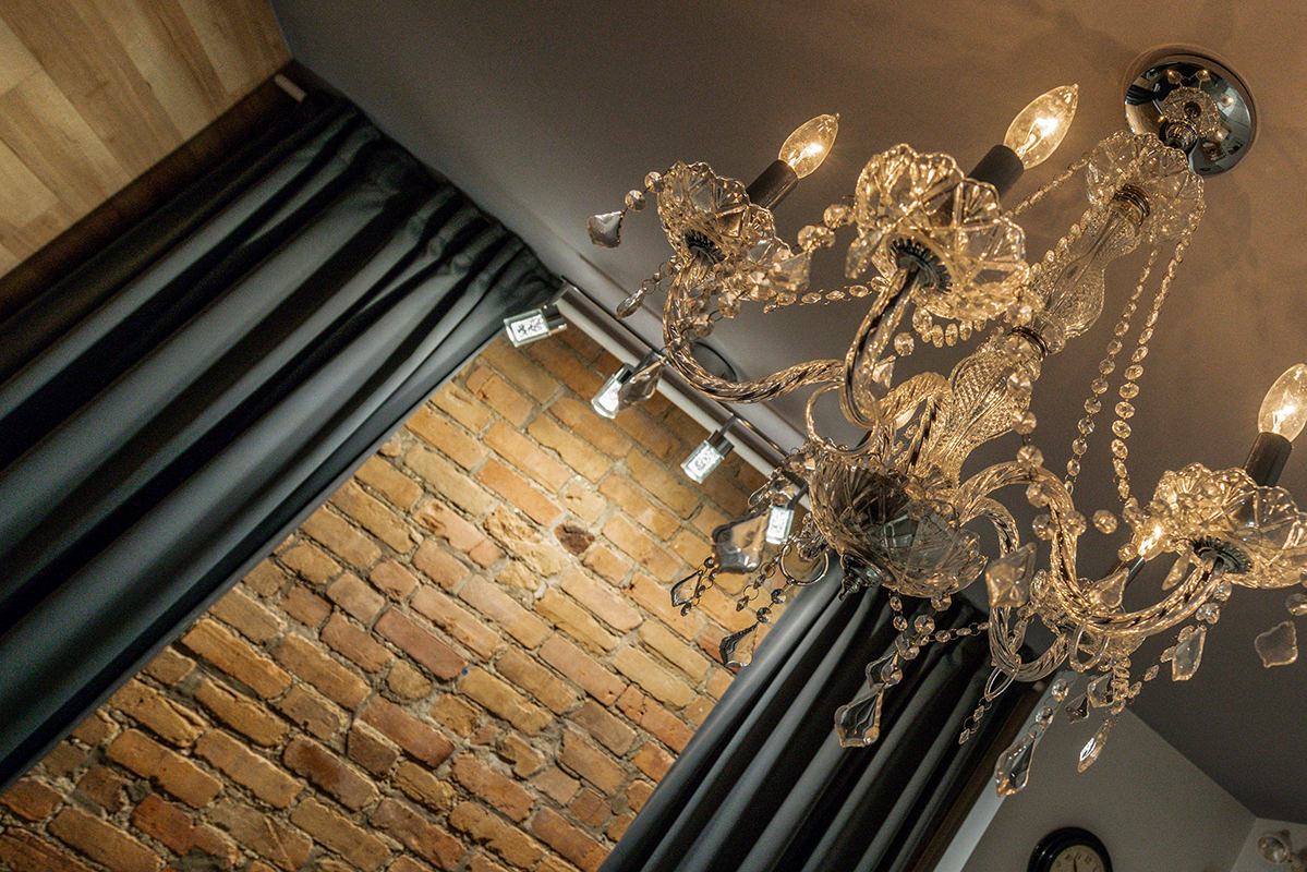 brick wall and crystal chandelier