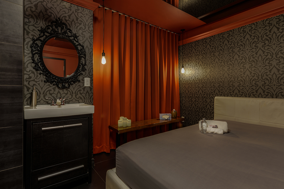 ecstasy room with a bed, curtains and a sink from massage adagio,